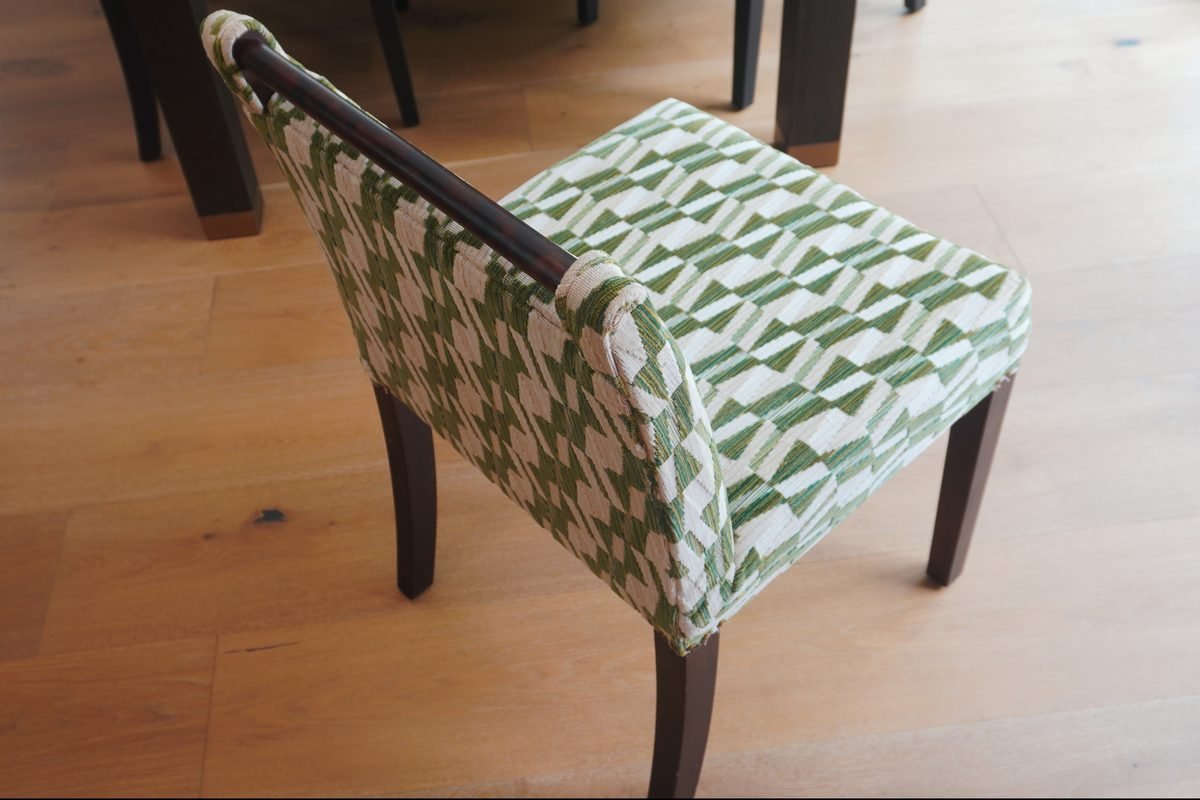 Detail shot of premium upholstery fabric and stitching on chair back